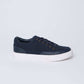 Men's navy blue casual sneaker with white sole, side view on plain background