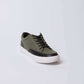 Olive green canvas sneaker with black accents and white sole, men's casual shoe