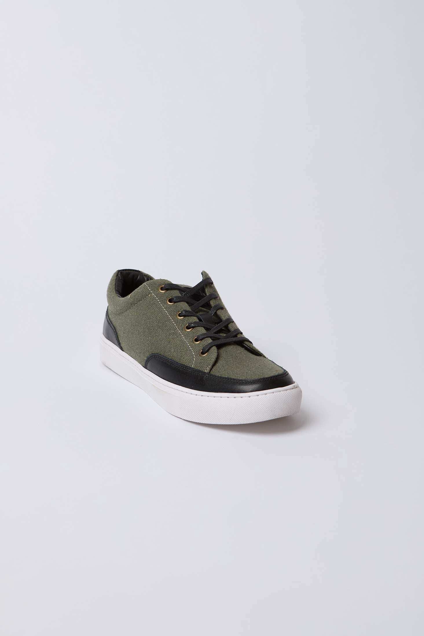 Olive green canvas sneaker with black accents and white sole, men's casual shoe