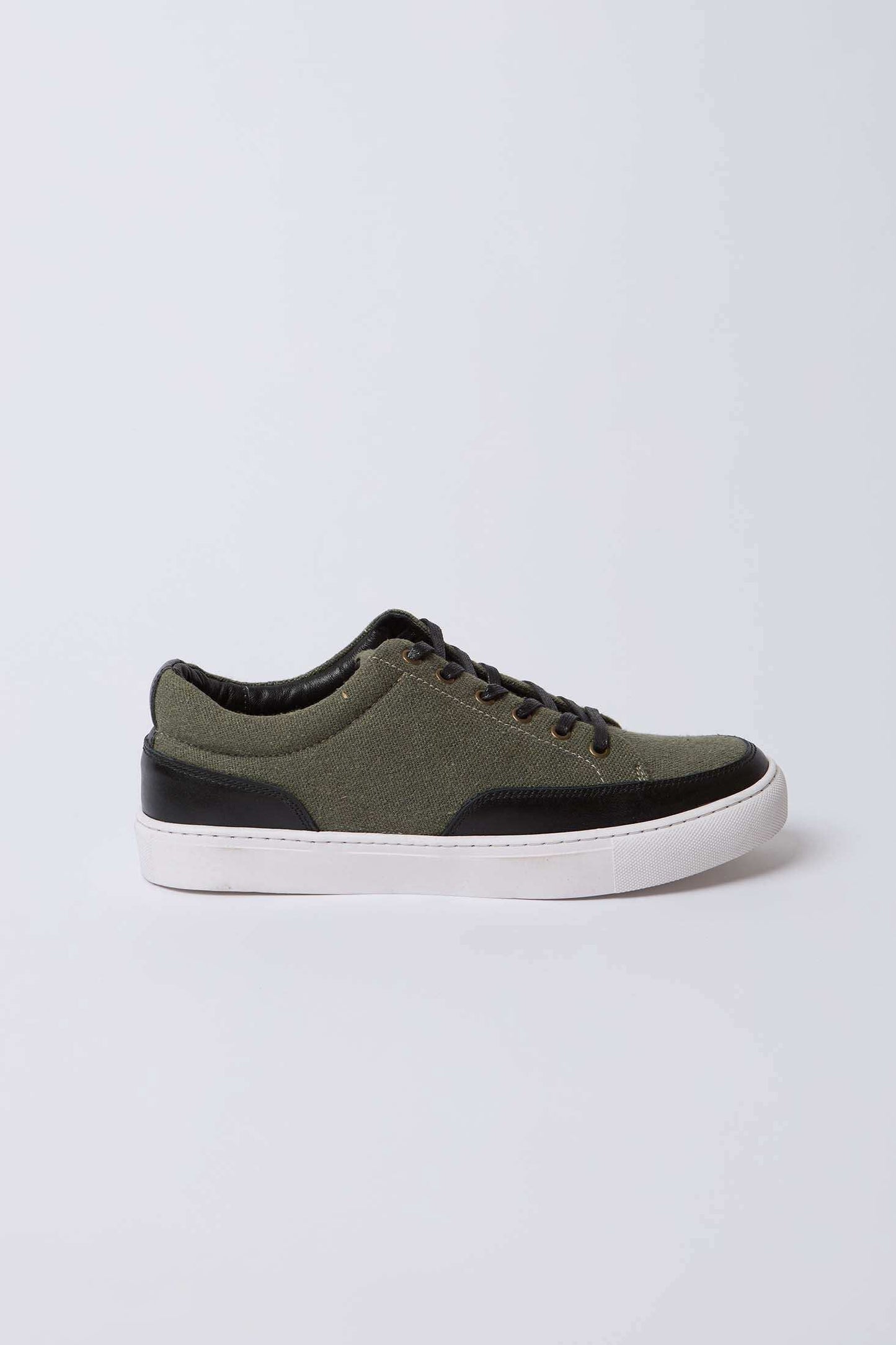 Olive green and black casual sneaker with white rubber sole on plain background
