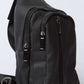 Black textured leather crossbody bag with zippered compartments and adjustable strap