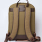 Back view of khaki backpack with brown adjustable straps and leather accents