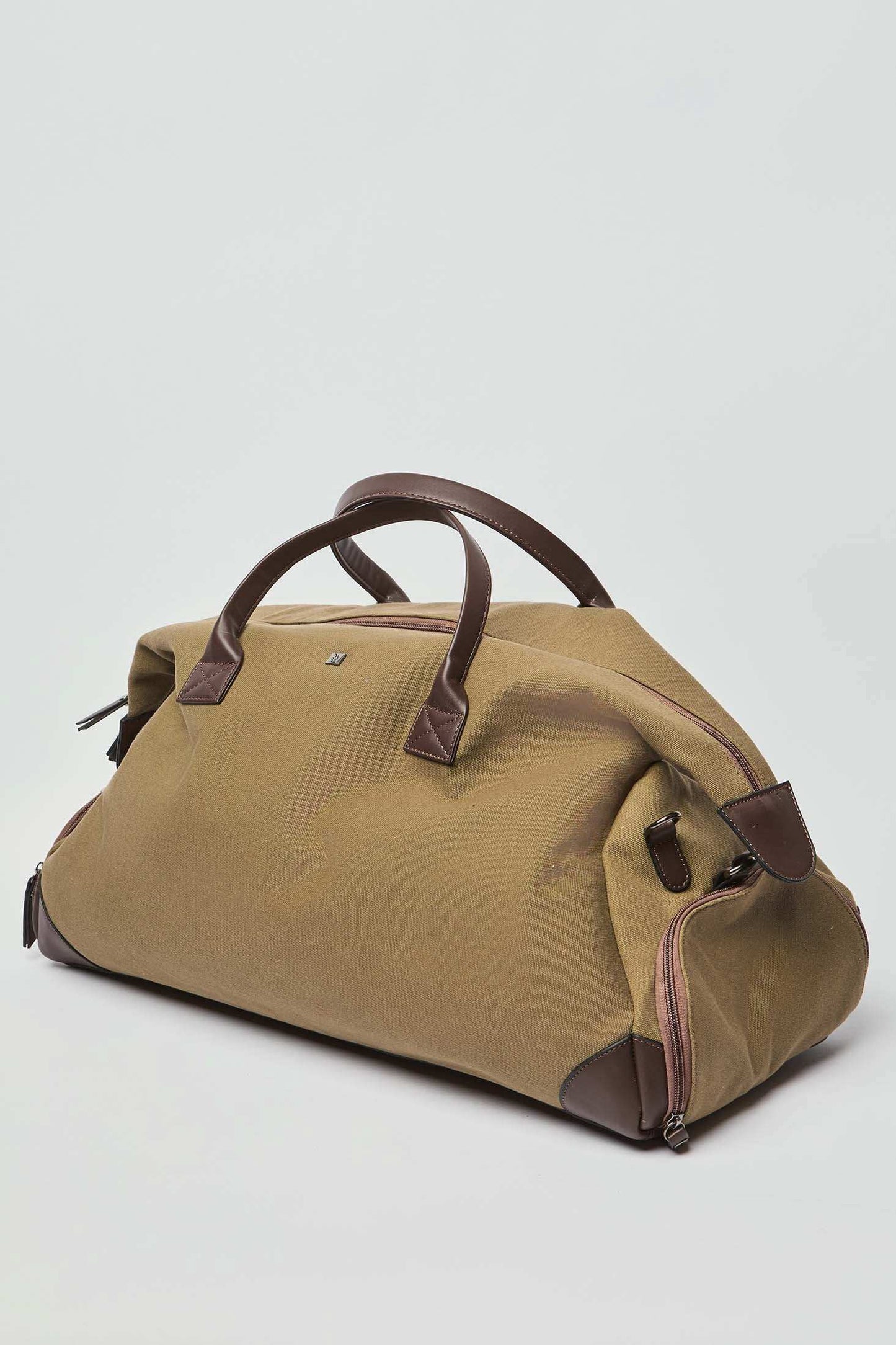 Brown canvas duffle bag with leather handles and accents on a plain background