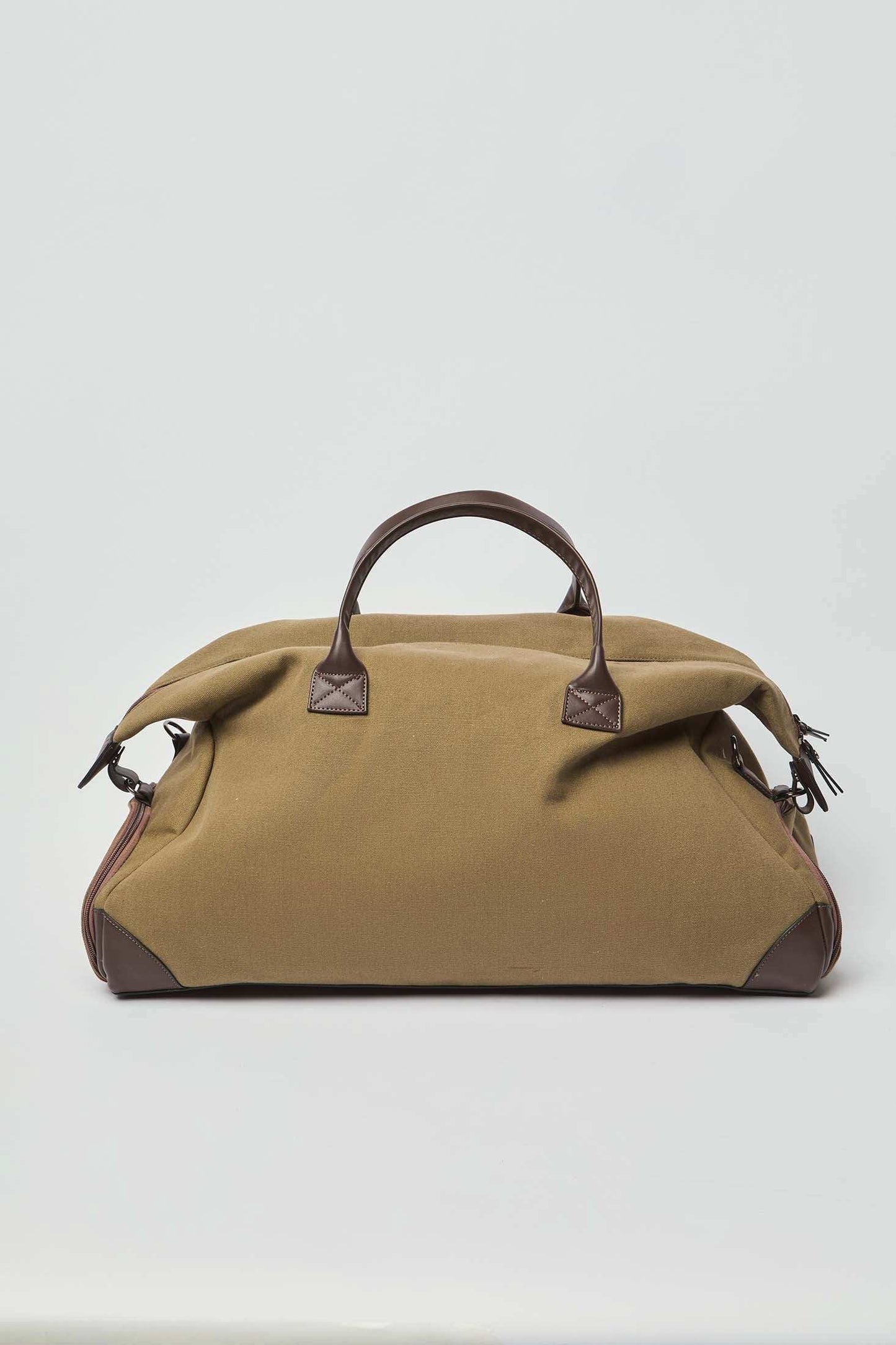 Olive green duffel bag with brown leather handles and accents on white background