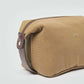 Brown canvas toiletry bag with leather trim and zipper, men's travel accessory.