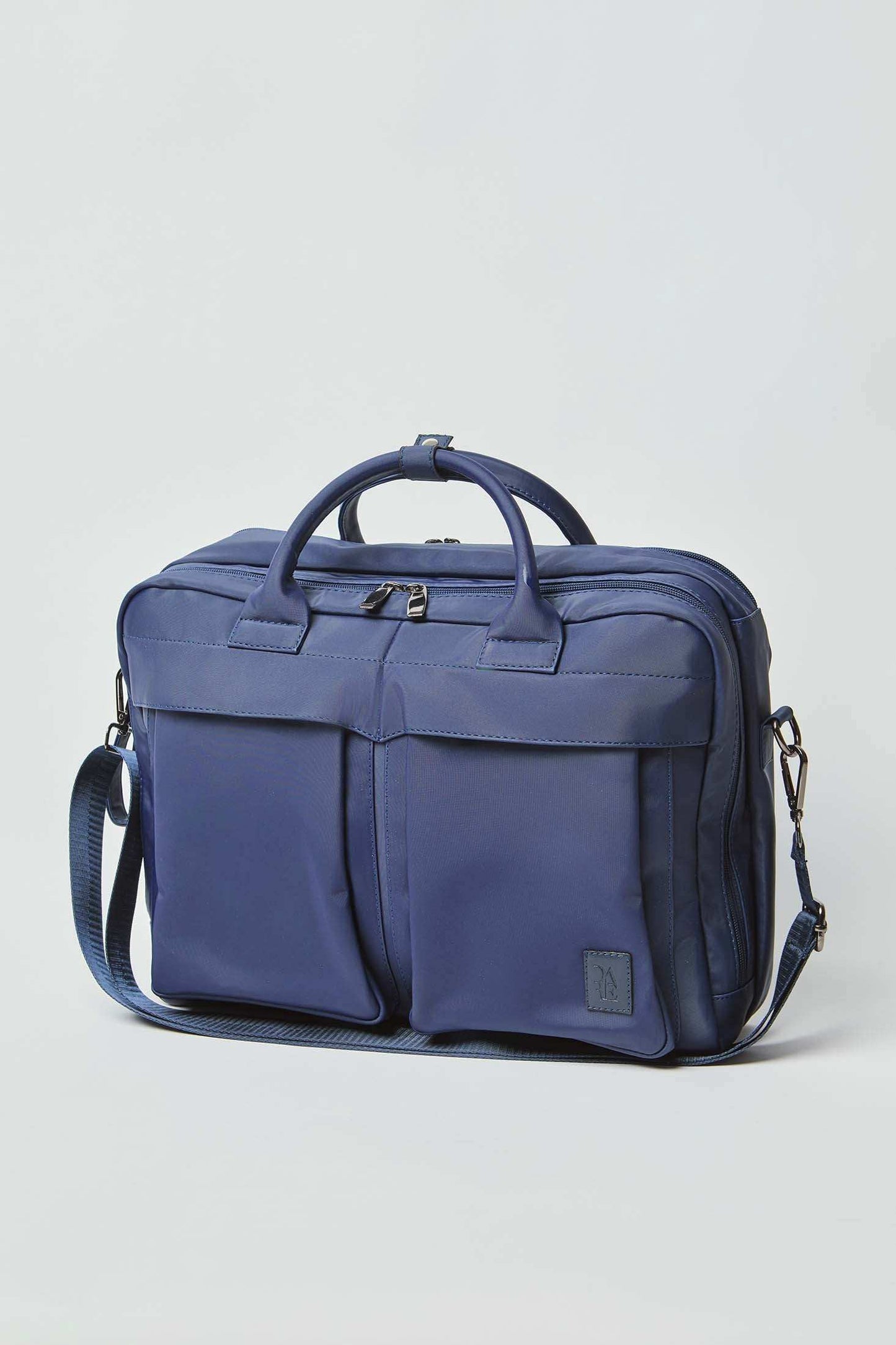 Navy blue men's messenger bag with top handles, dual front pockets, and adjustable shoulder strap