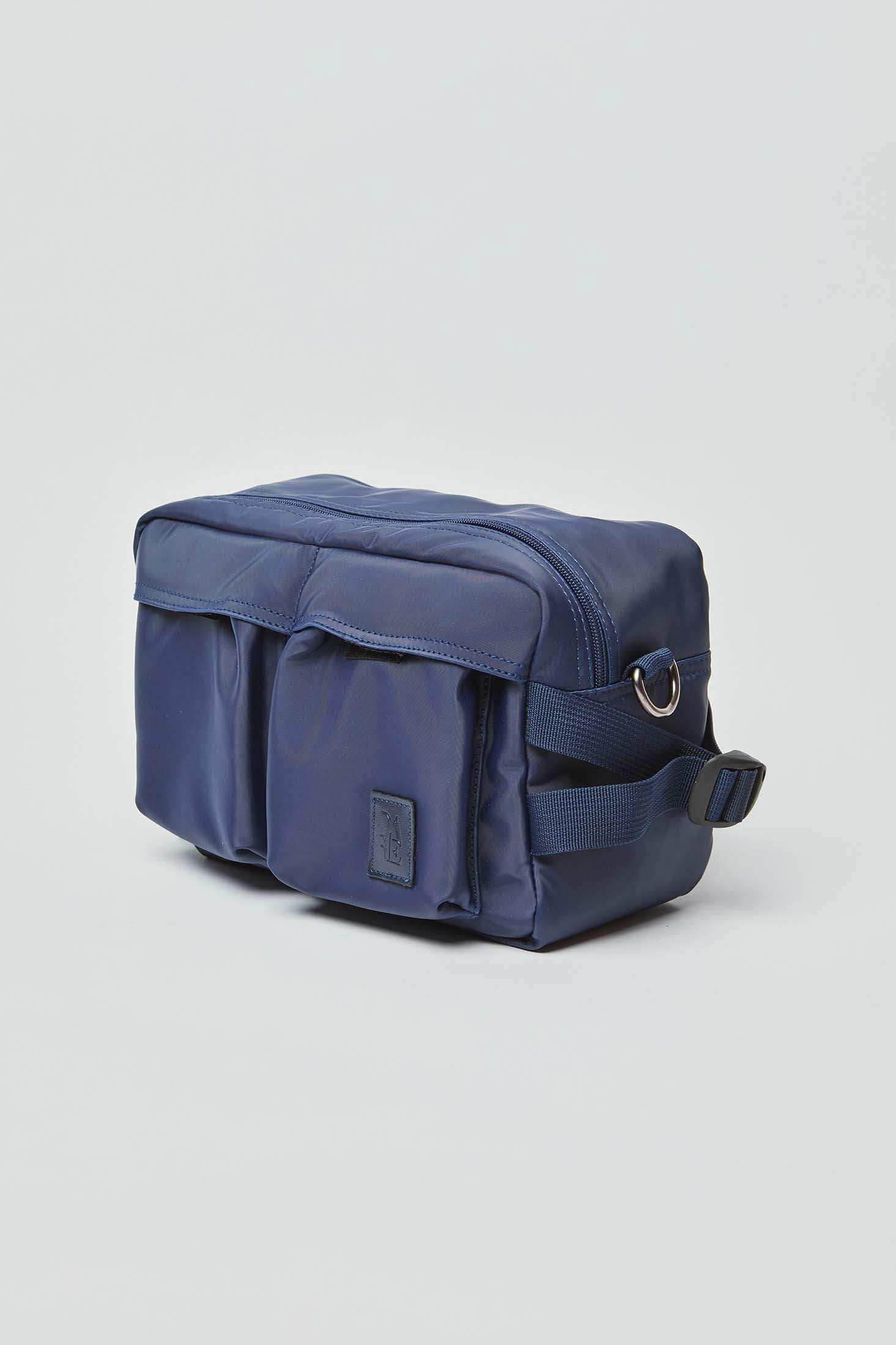 Navy blue rectangular crossbody bag with front pockets, adjustable strap, and zipper closure