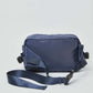 Navy blue crossbody messenger bag with adjustable strap on white background