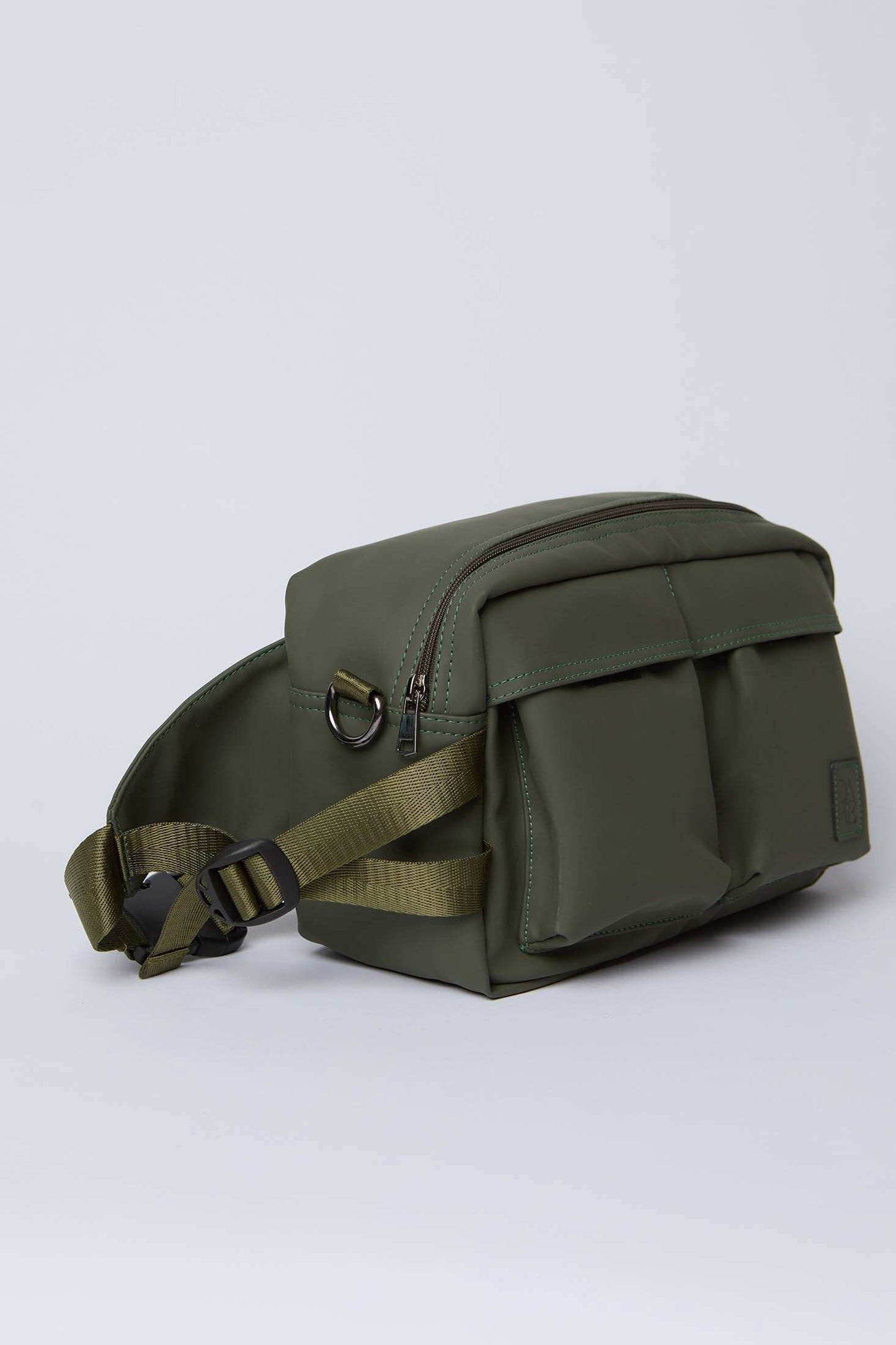 Olive green crossbody bag with front pockets and adjustable strap on a plain background