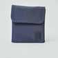Navy blue compact pouch with front flap and stitched patch, minimal unisex accessory