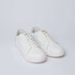 Dalydress white leather sneakers with tan heel accent on a light background
