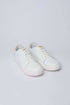 Dalydress white leather sneakers with tan heel accent on a light background