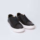 Dalydress men's black leather sneakers with white sole on plain background