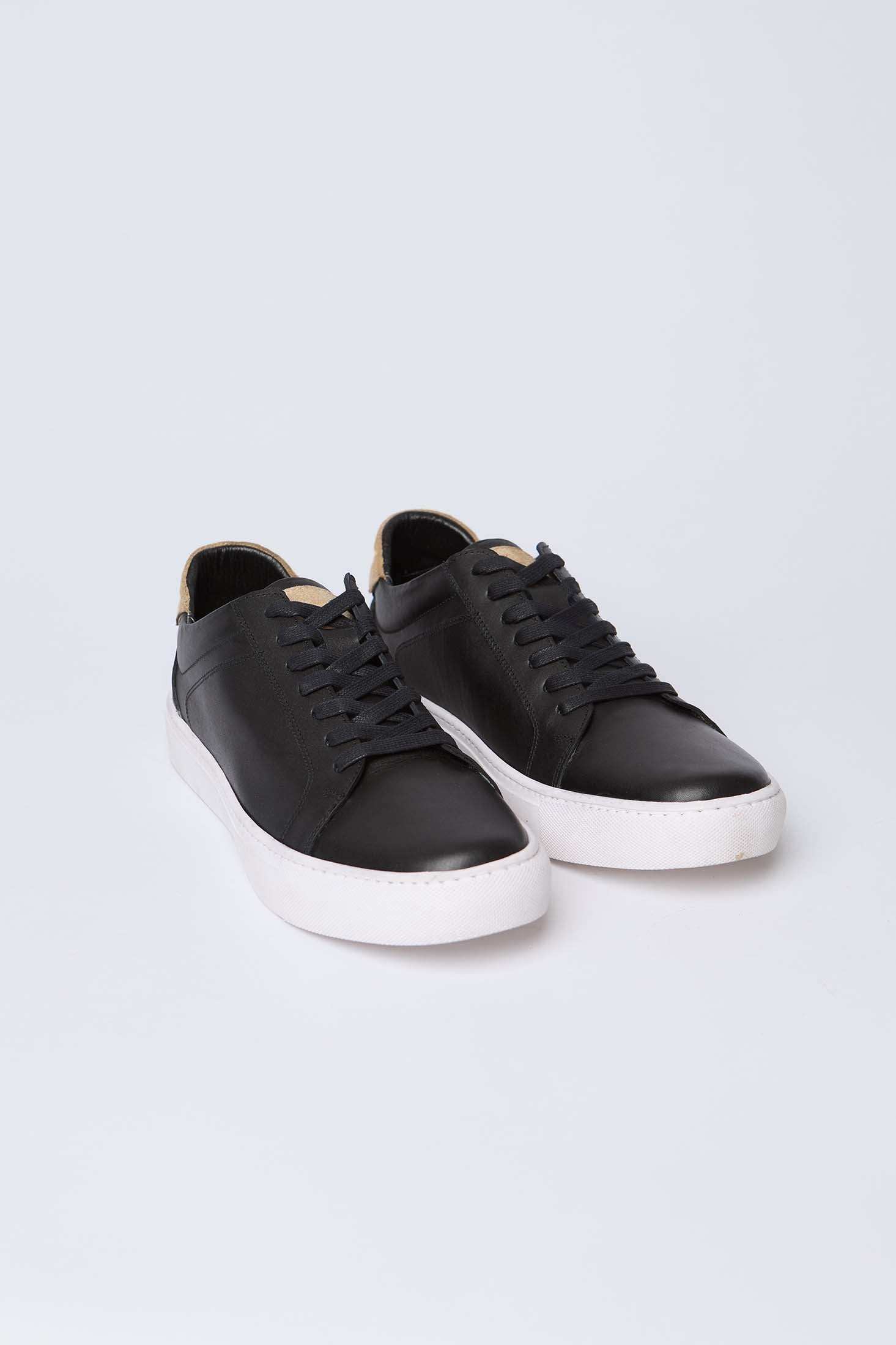 Dalydress men's black leather sneakers with white sole on plain background