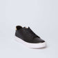 Dalydress black leather sneaker with white rubber sole, casual men's footwear on light background