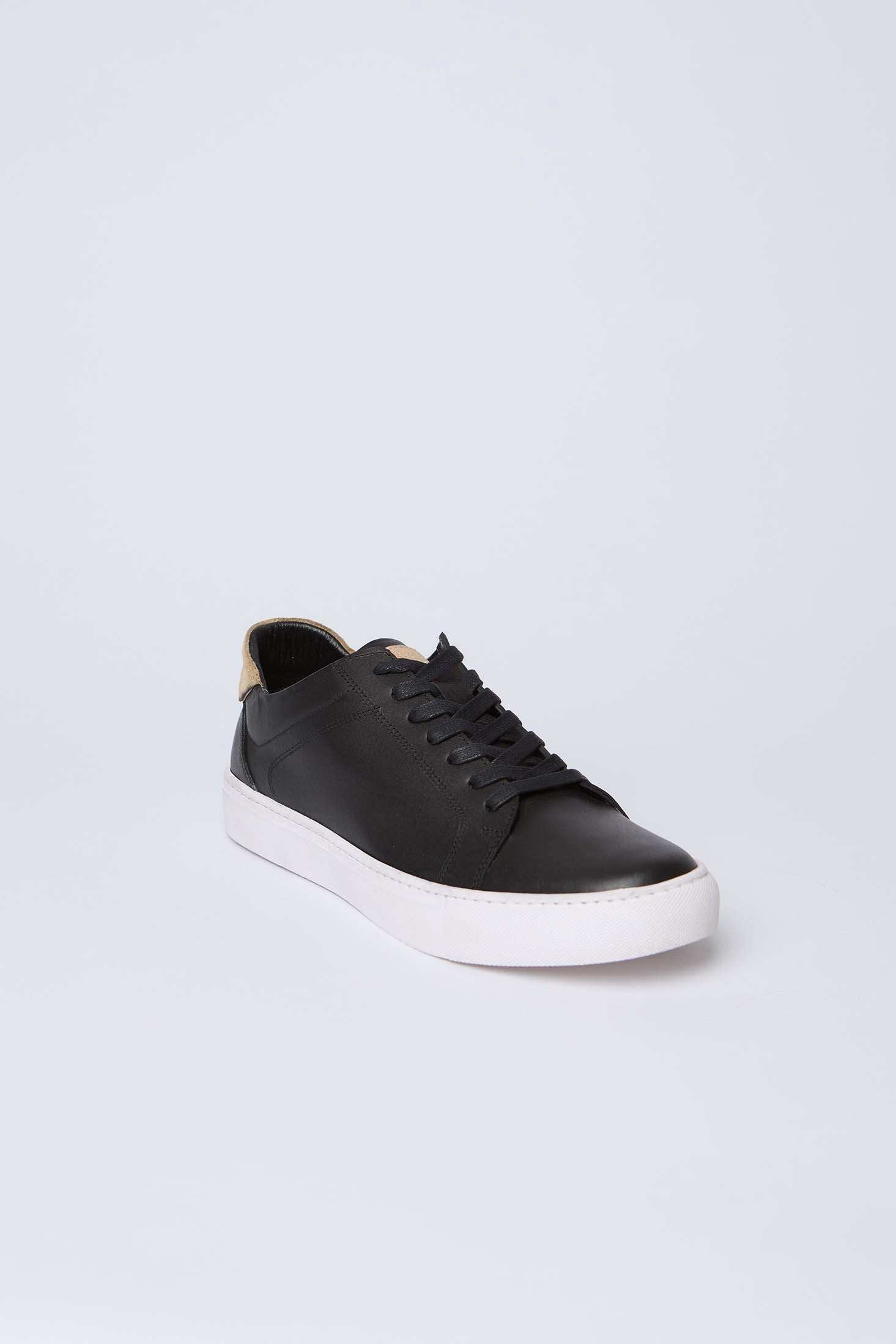 Dalydress black leather sneaker with white rubber sole, casual men's footwear on light background