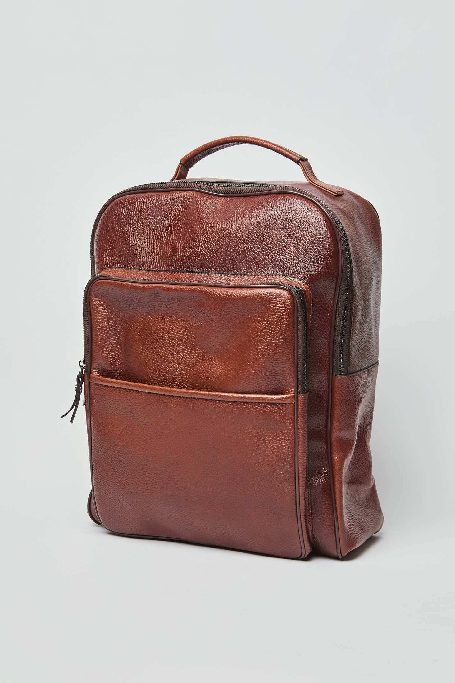 Dalydress brown leather backpack with front pocket and top handle on white background