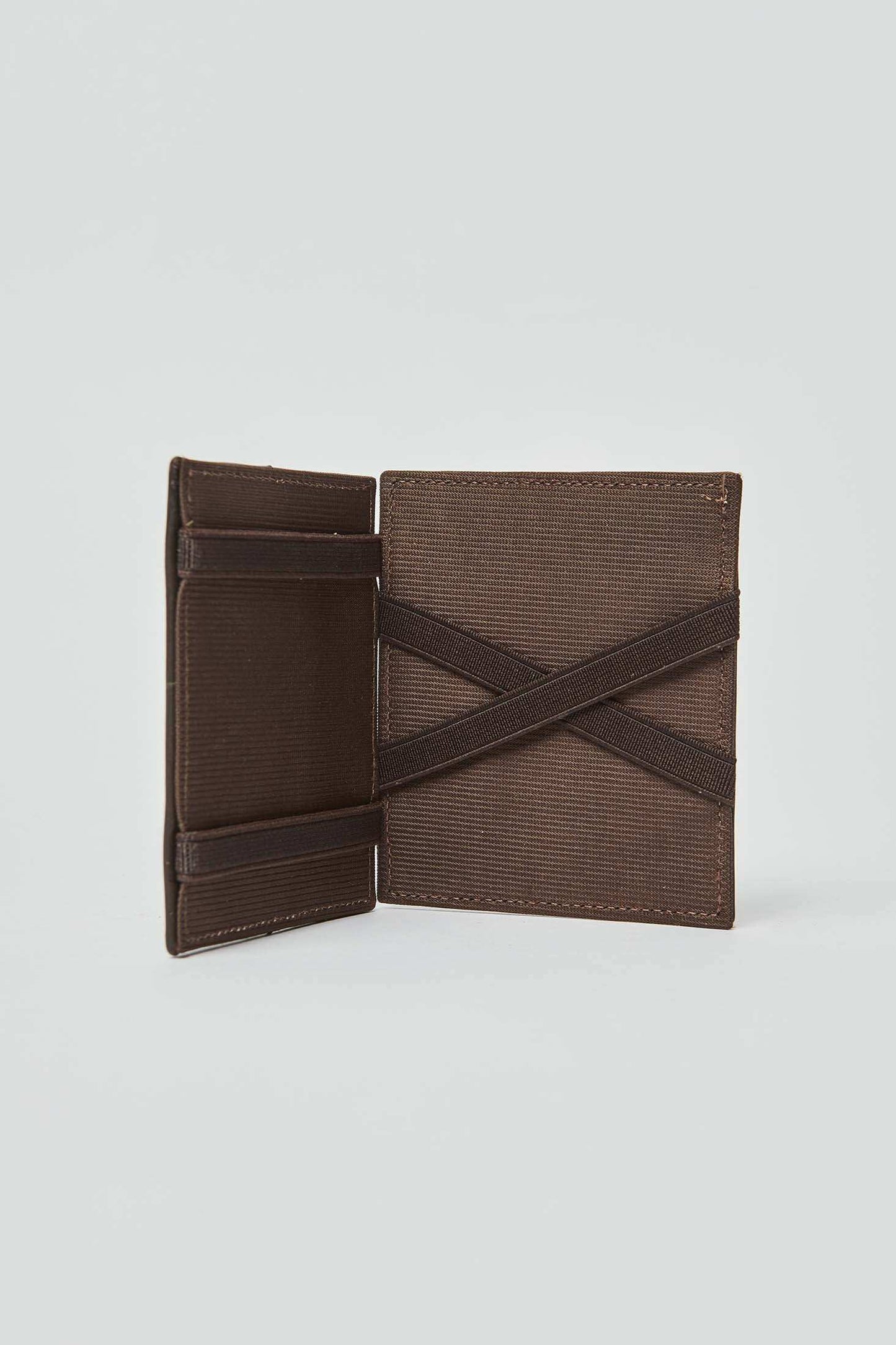 Brown Dalydress men's wallet with elastic bands, open and standing on a light background