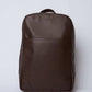 Dalydress brown leather backpack with minimalist design on plain background