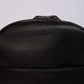 Dalydress black leather backpack with embossed logo on plain background