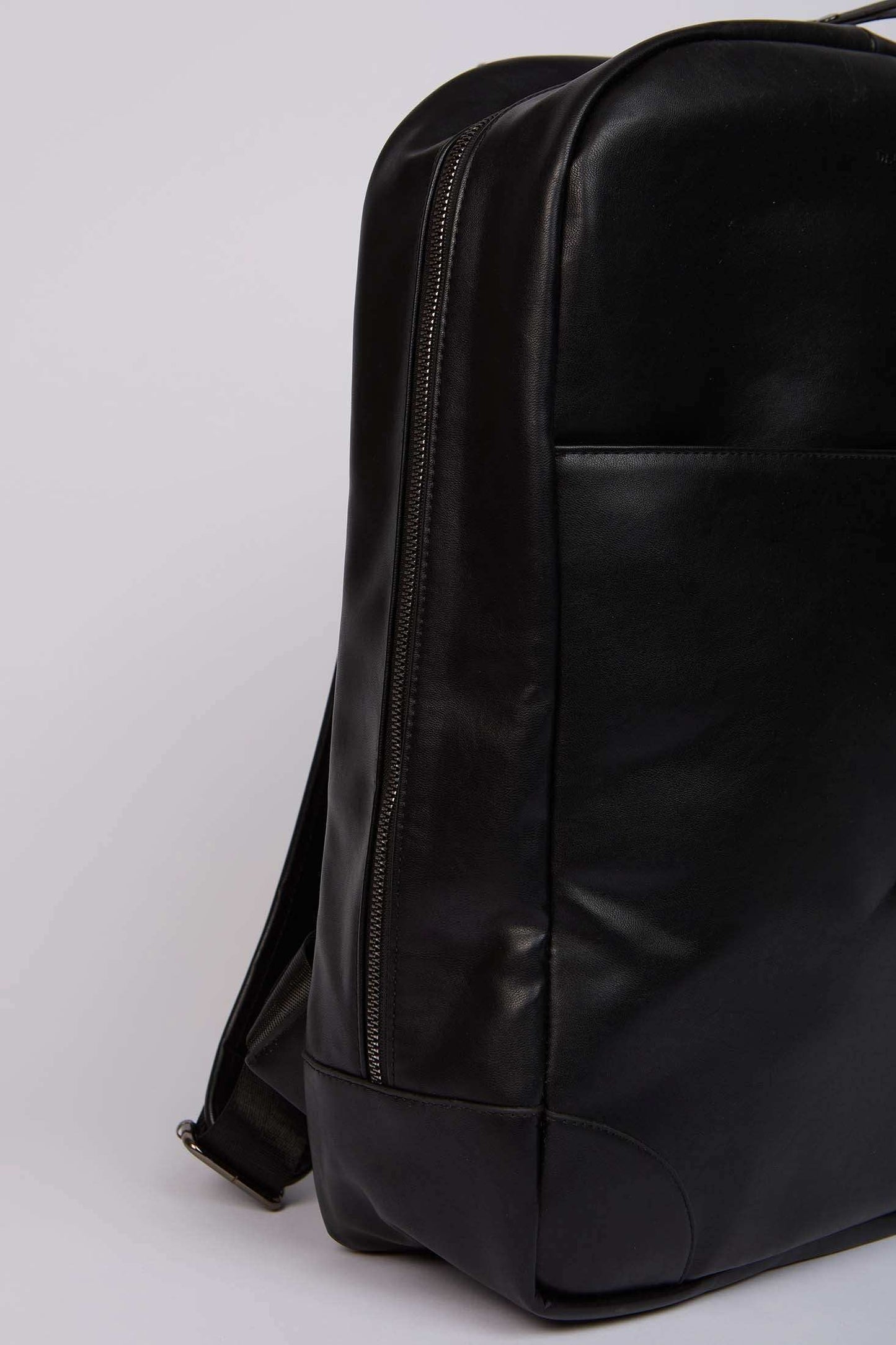 Dalydress black leather backpack with zipper and sleek modern design, close-up view