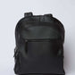 Dalydress black leather backpack with front zipper pocket, minimalist design on white background