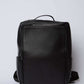 Dalydress black leather backpack with top handle and front zipper pocket on white background