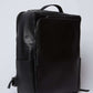 Dalydress black leather backpack with front zipper pocket and handle, minimalist design
