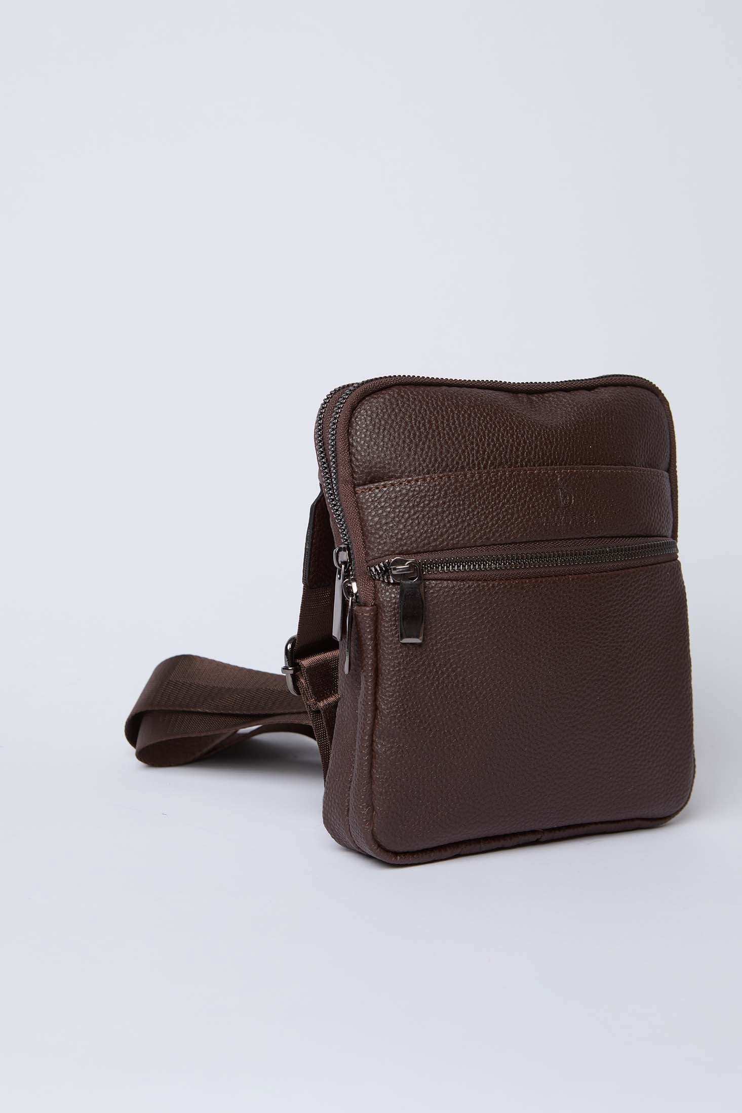 Brown leather crossbody bag with zipper pockets and adjustable strap on white background