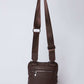 Brown leather crossbody bag with adjustable strap and front zipper pocket