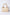 Beige textured handbag with ruched handle and gold hardware on white background