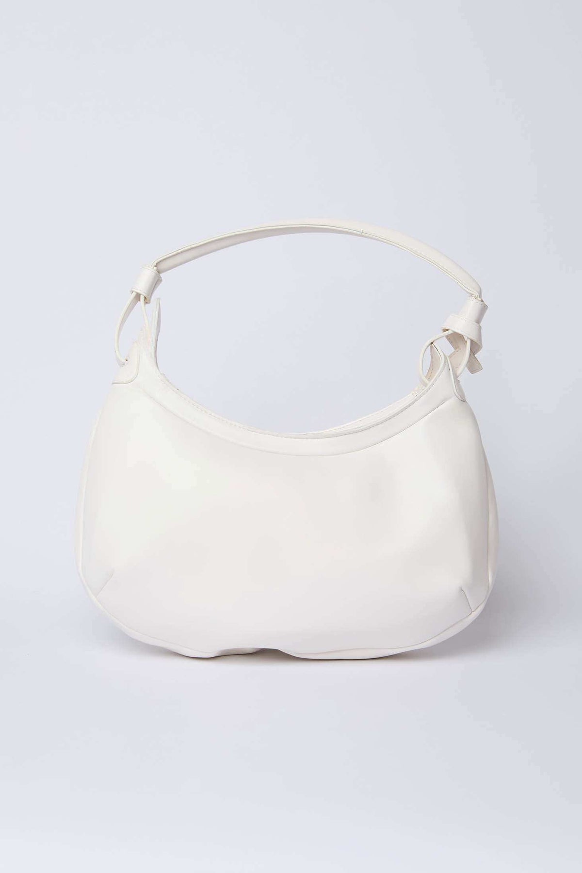 White leather shoulder bag with curved design and adjustable strap on plain background
