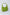 Green leather shoulder bag with zipper and multicolor tassel keychain on white background