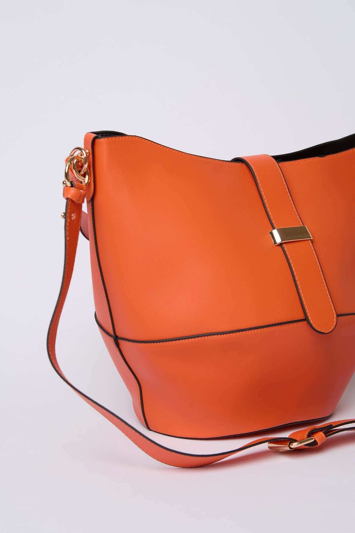 Orange leather shoulder bag with gold buckle and adjustable strap, modern women's accessory