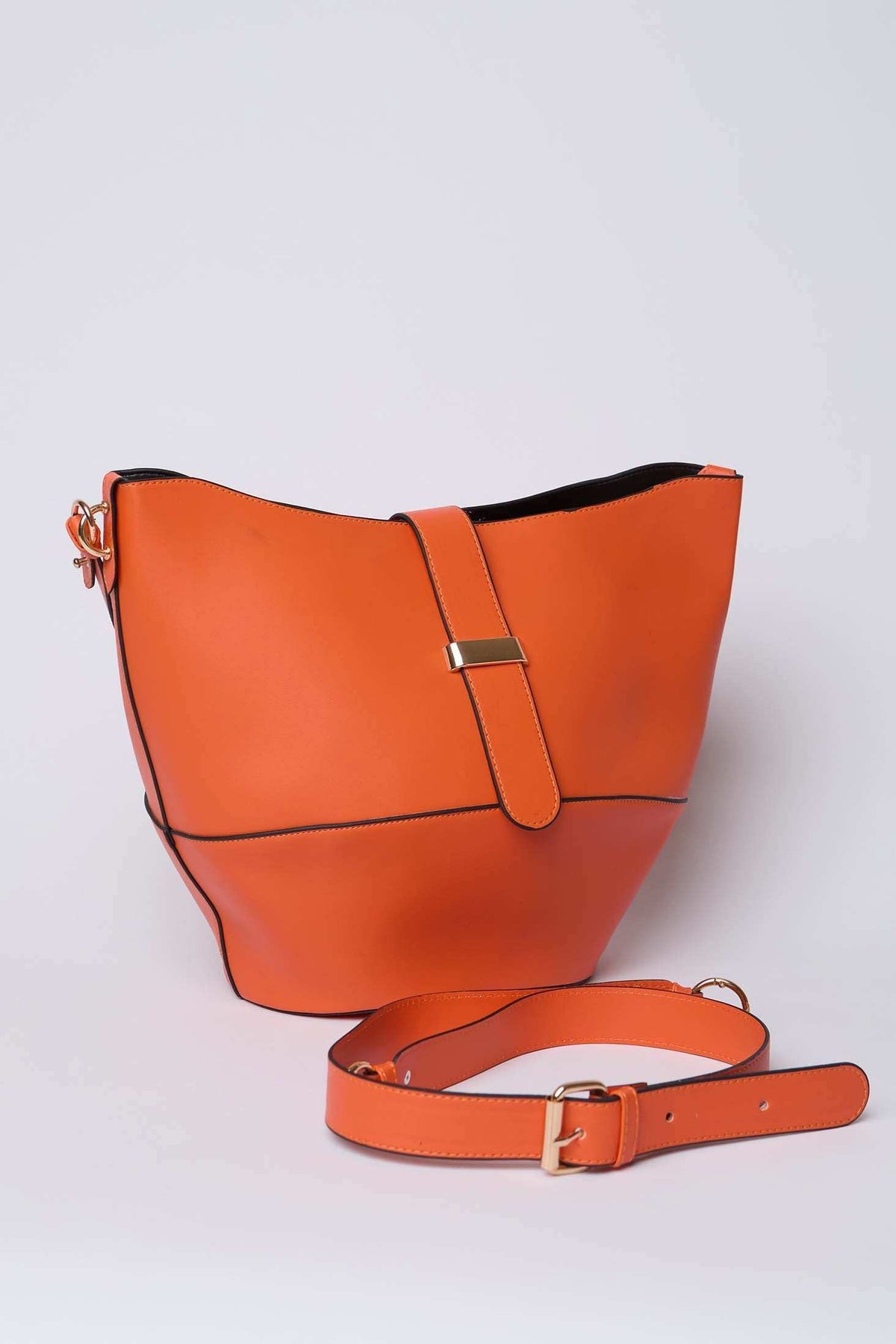 Orange leather bucket bag with adjustable strap and gold buckle on a plain background