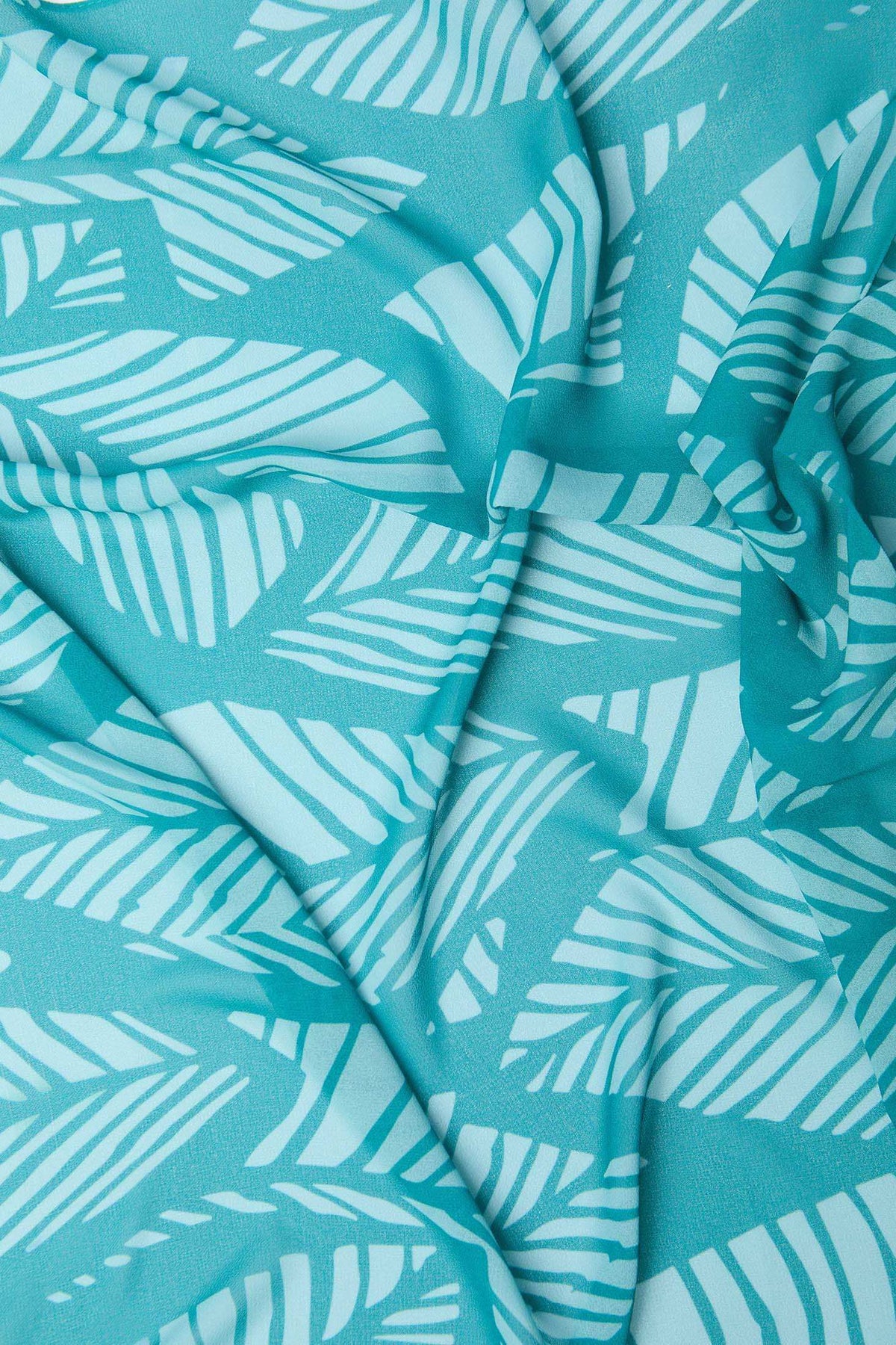 Turquoise fabric with white abstract leaf pattern, lightweight and textured textile