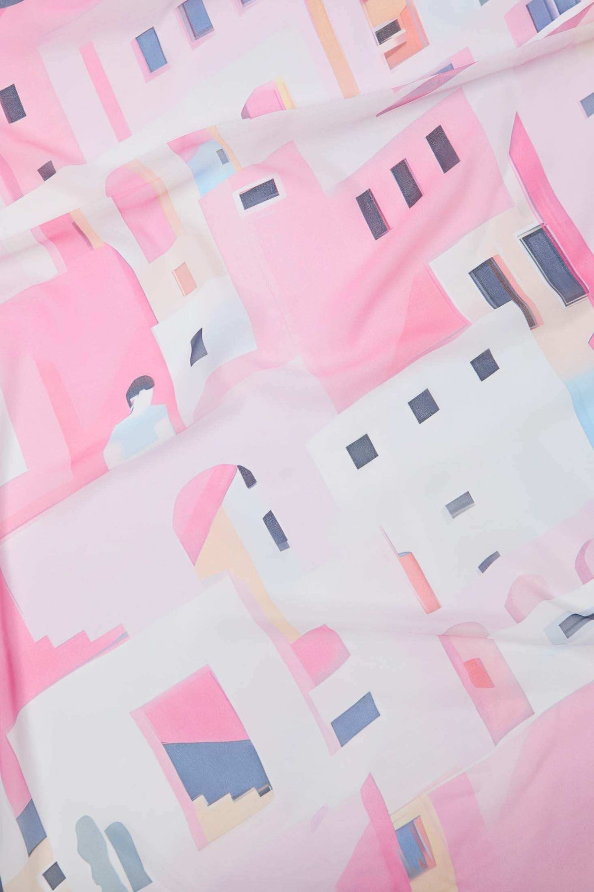 Abstract pink and white fabric with geometric building and window print pattern.