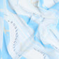 Light blue and white patterned fabric with abstract line and text design, soft texture