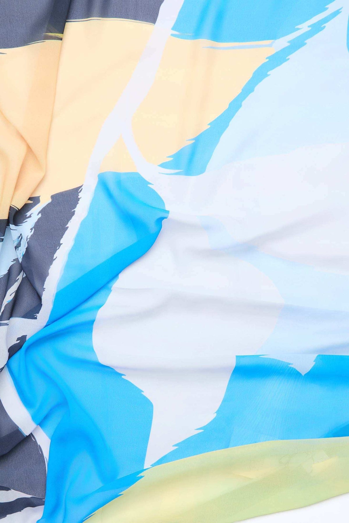 Abstract pastel and blue patterned fabric with soft folds and brushstroke design