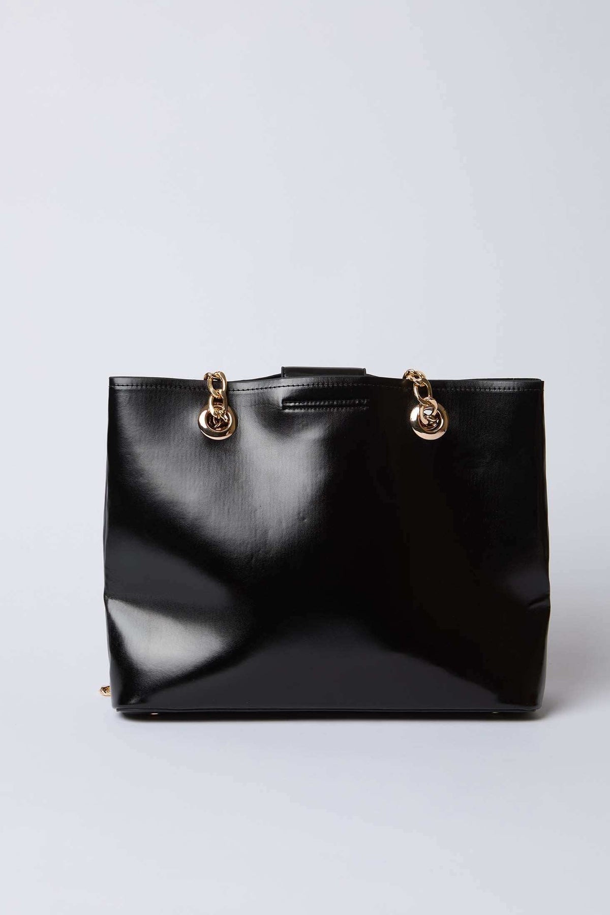 Dalydress black leather handbag with gold chain straps on white background
